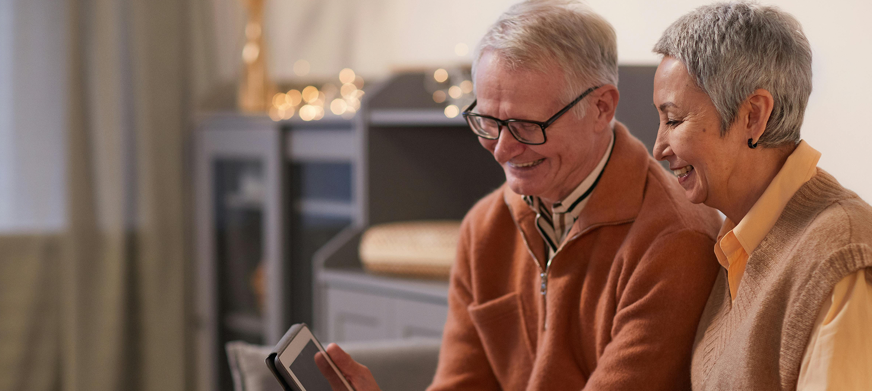 Couple on tablet in living room